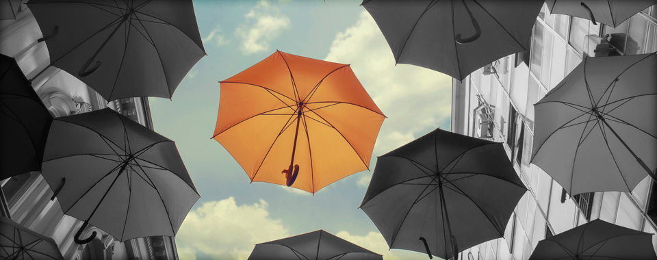 a bunch of umbrellas fall from the sky